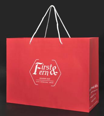 Red paper bag, white card (TPI) 150 gsm . Printed red background, PP rope handles cut 50 cm each side